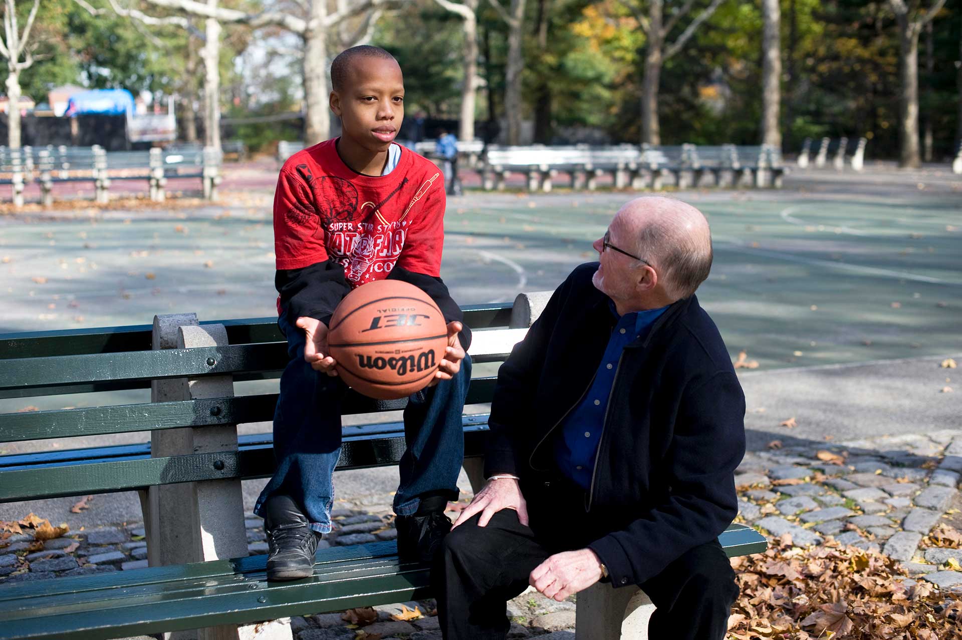 boy mentor mentee park bench 55+ basketball